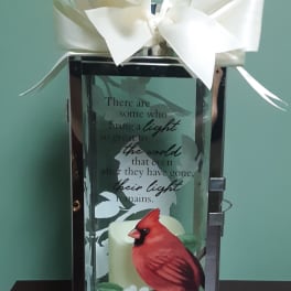 Decorative lantern with a white bow and cardinal design