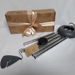 Gift box with ribbon and several metal wind chimes with tags