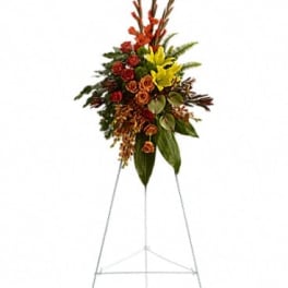 Tall floral spray on a metal easel with red, orange, and yellow flowers