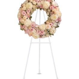 Pastel floral wreath on a white easel stand