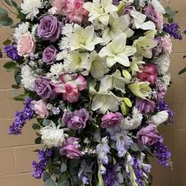 Large standing floral spray with pink, purple, and white blooms