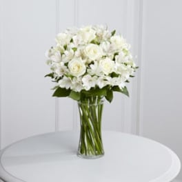 White rose bouquet in a clear glass vase