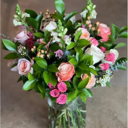 Bouquet of pink and white roses in a clear glass vase