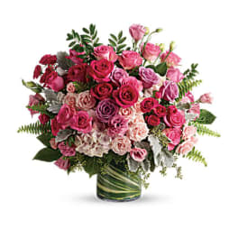 Pink and purple rose bouquet in a glass vase
