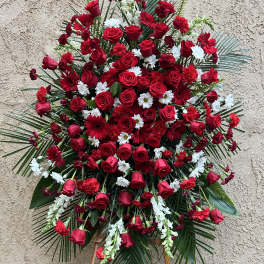 Large standing floral spray with red roses and white daisies