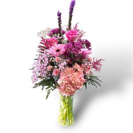 Pink and purple mixed bouquet in a clear glass vase