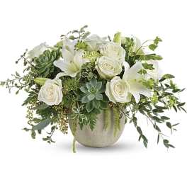 White roses and lilies arranged with succulents in a round vase