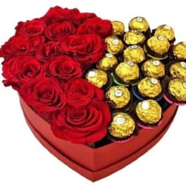 Heart-shaped box with red roses and gold-wrapped chocolates