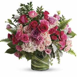 Pink and lavender rose bouquet in a glass vase