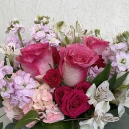 Bouquet of pink roses and pale alstroemeria with light lavender flowers