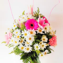 Pink and white mixed flowers in a clear glass vase