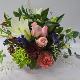 Mixed bouquet with pink roses, white lilies, and colorful blooms