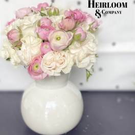 Pink and white flower bouquet in a white vase