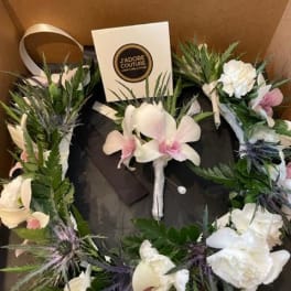 Floral wreath with white and pink orchids in a gift box