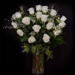 White roses arranged in a clear glass vase