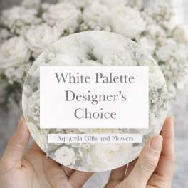 Hands holding a round card over a white flower arrangement