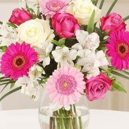 Pink and white mixed bouquet in a clear glass vase