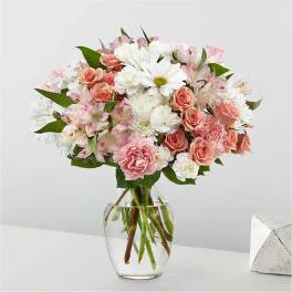 Pink and white mixed bouquet in a clear glass vase