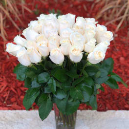 Bouquet of white roses in a clear glass vase
