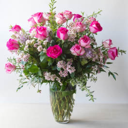 Pink roses arranged in a clear glass vase
