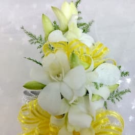 White floral bouquet with yellow ribbon accents on sheer fabric