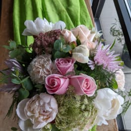 Bouquet of pink and white roses with mixed blooms and greenery
