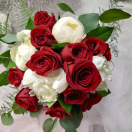 Bouquet of red and white roses with greenery