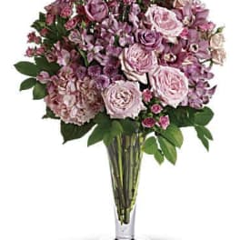 Pink and lavender rose bouquet in a clear glass vase