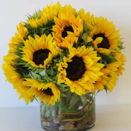 Bouquet of yellow sunflowers in a glass vase