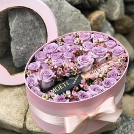 Pink hatbox with lavender roses and a Moët bottle