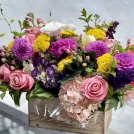 Colorful mixed flower arrangement in a wooden box