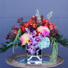 Colorful mixed bouquet in a clear cube vase