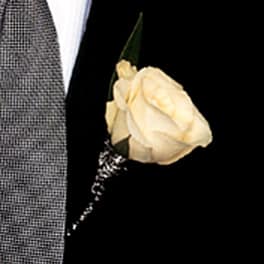 Cream rose boutonniere on a suit lapel