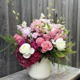 Pink and white floral arrangement in a white vase