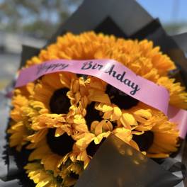 Yellow flower bouquet with a pink Happy Birthday ribbon