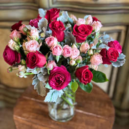 Bouquet of pink and red roses in a clear glass vase
