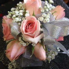 Pink rose bouquet with white filler flowers and silver ribbon