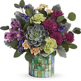 Mixed bouquet with succulents and purple flowers in a mosaic vase