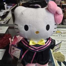 Hello Kitty plush in a graduation outfit with a small rose bouquet