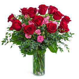 Red and pink roses in a clear glass vase