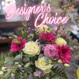 Mixed bouquet with pink gerbera daisies and cream roses in a glass vase
