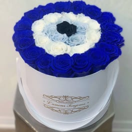 Round box of blue, white, and black roses