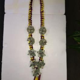 Braided ribbon lei with folded dollar bills