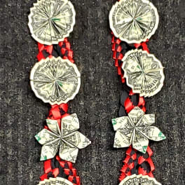 Braided red and black ribbon necklace with folded paper flower and coin-like medallions
