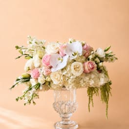 Pink and white floral arrangement in a clear glass vase