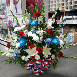 Large red, white, and blue floral arrangement with lilies and carnations