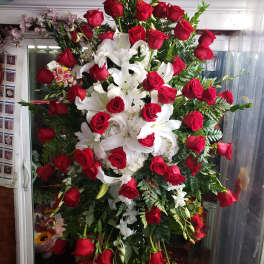 Large standing arrangement of red roses and white lilies