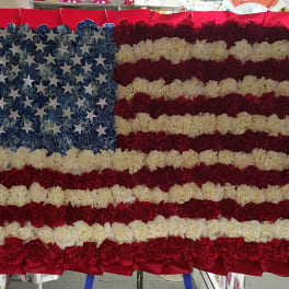 Floral American flag made of red, white, and blue carnations