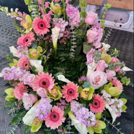 Pink and white floral wreath with gerbera daisies, roses, and calla lilies