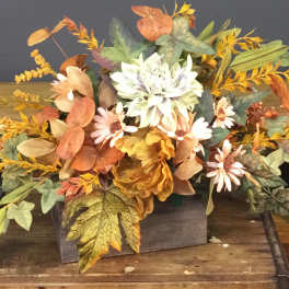 Autumn floral arrangement with white and peach daisies in a wooden box